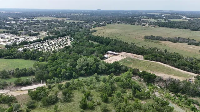 a view of a field with a tree in the background