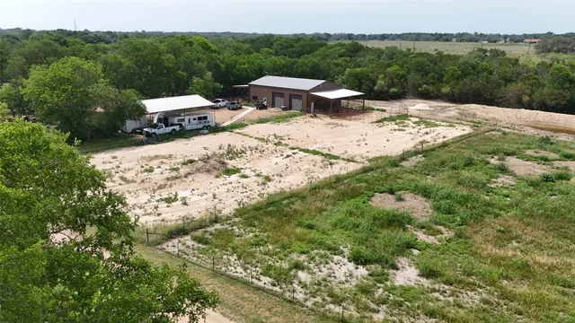 an aerial view of a house with a yard and sitting area