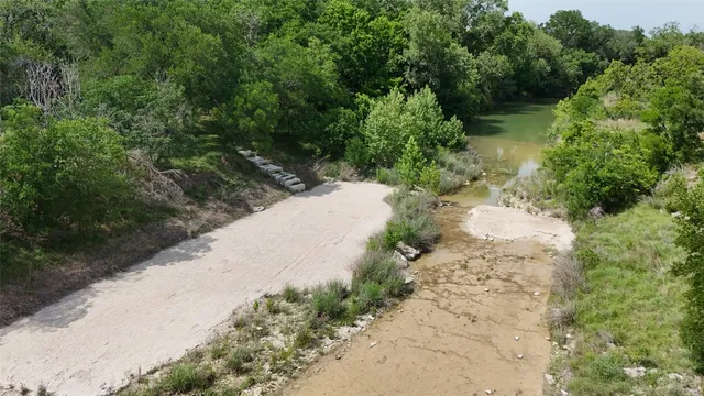 a backyard of a house with lots of green space and fountain