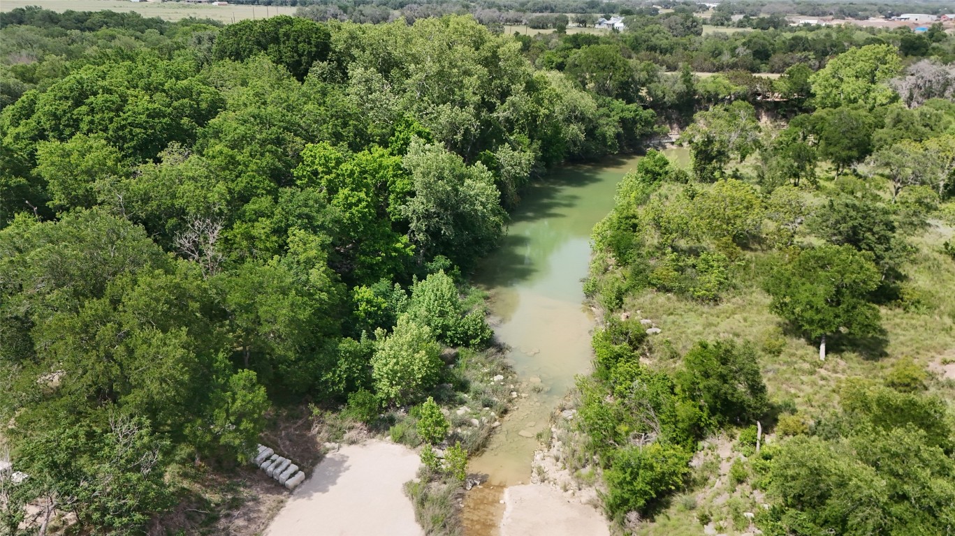 835 County Road 256 Liberty Hill, TX 78642 - Photo 31 of 34 Drone / aerial view of a heavily wooded area and a nearby body of water