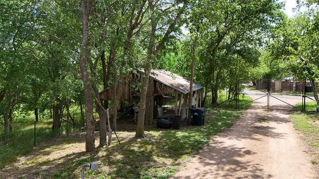 a backyard of a house with barbeque oven