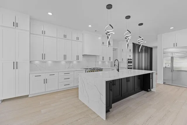a kitchen with white cabinets and white appliances