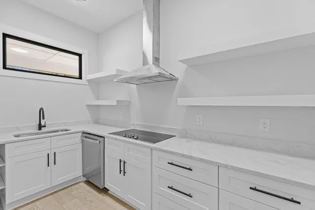 a spacious bathroom with a granite countertop sink and a large mirror