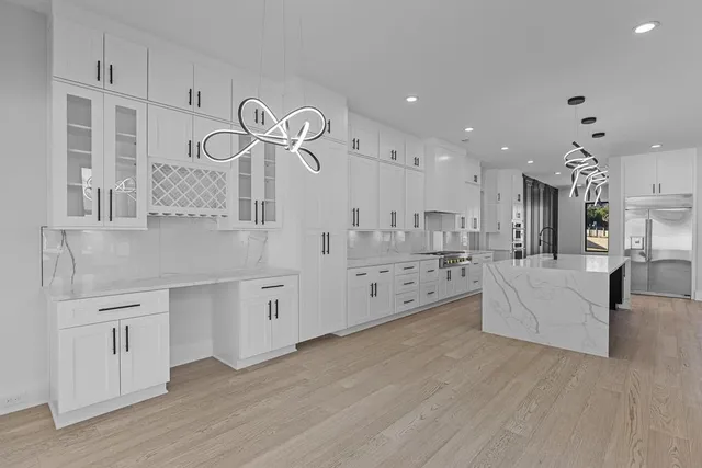 a view of an empty room with a fireplace and a window