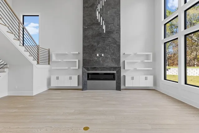 a large white kitchen with kitchen island a sink stainless steel appliances and cabinets