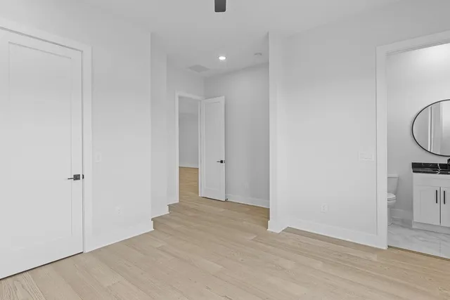 a view of an empty room with wooden floor