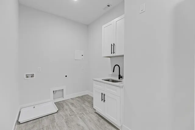 a view of a big room with wooden floor and windows