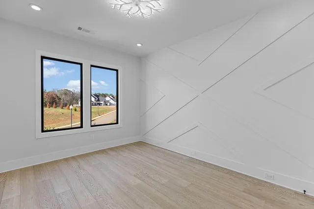 a kitchen with white cabinets sink and stainless steel appliances