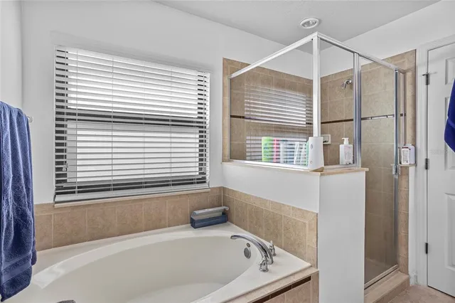 a bathroom with a bathtub and a window