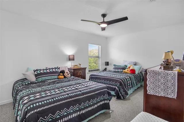 a bedroom with two beds and window