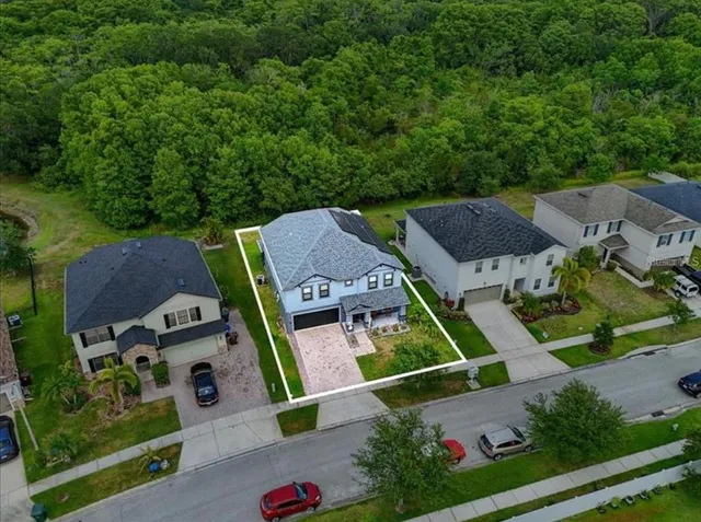 an aerial view of multiple houses with yard