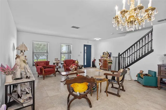 a living room with furniture and a chandelier