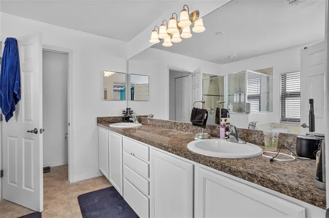 a bathroom with a sink double vanity and a mirror