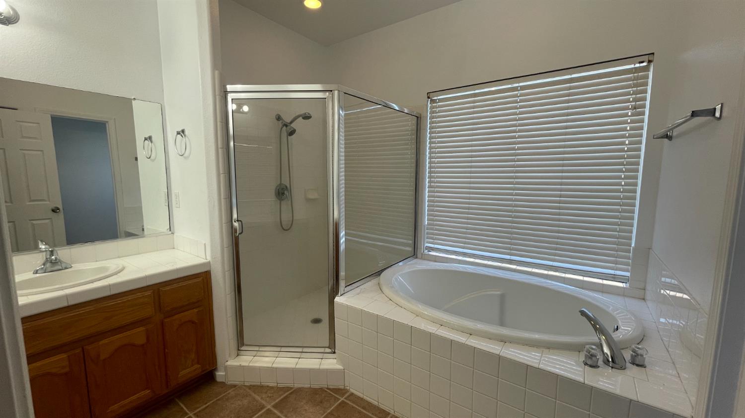 1400 Bay Street Lemoore, CA 93245 - Photo 14 of 21 a bathroom with a tub sink and mirror