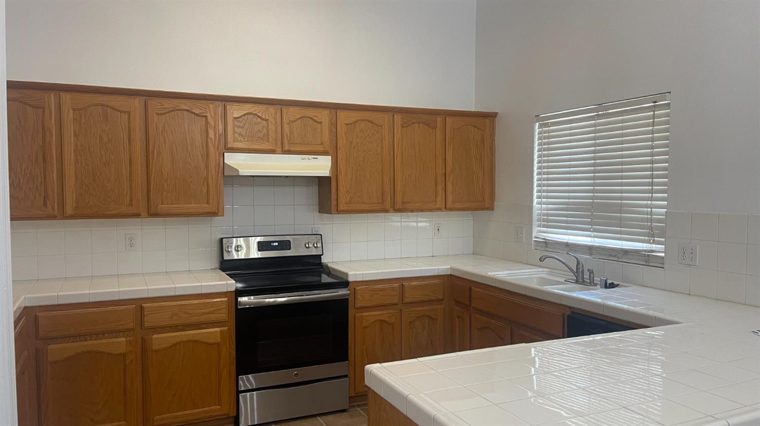 1400 Bay Street Lemoore, CA 93245 - Photo 20 of 21 a kitchen with a sink cabinets and a window