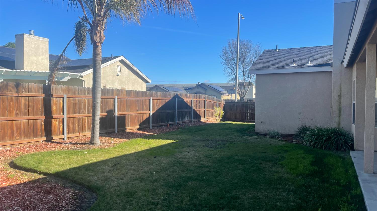 1400 Bay Street Lemoore, CA 93245 - Photo 3 of 21 a view of a house with backyard and a tree