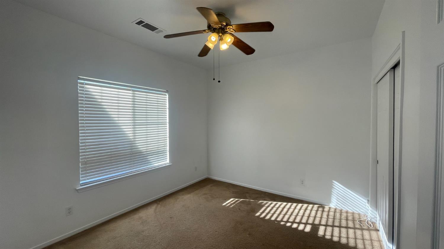 1400 Bay Street Lemoore, CA 93245 - Photo 8 of 21 a view of room with a ceiling fan and window