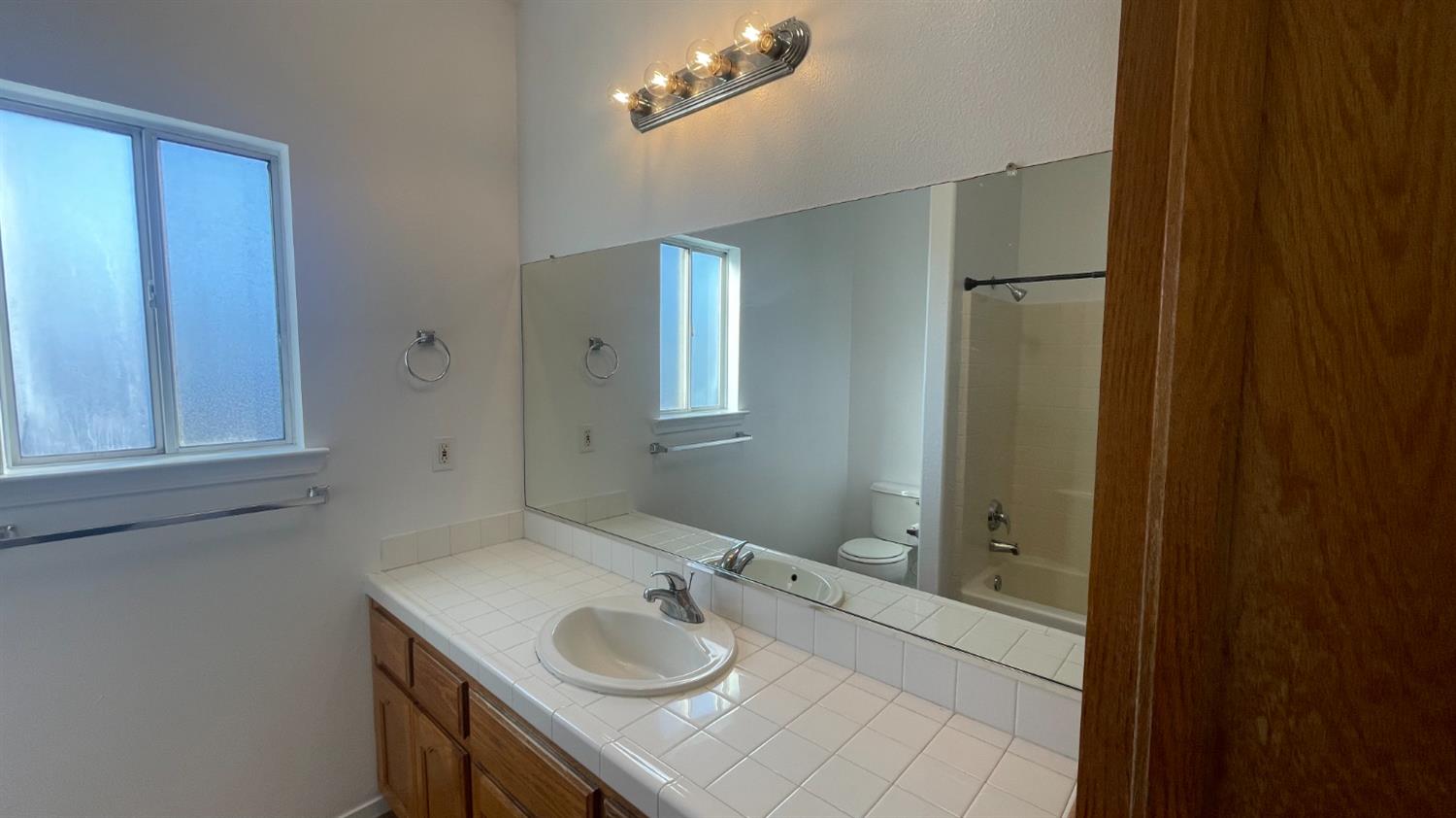 1400 Bay Street Lemoore, CA 93245 - Photo 10 of 21 a bathroom with a sink and a mirror