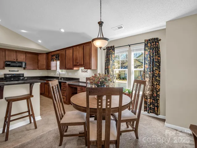a dining room with furniture and window