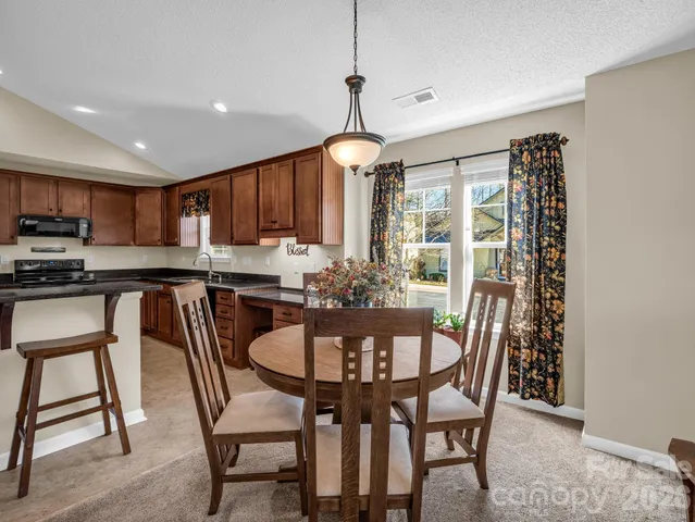 a kitchen with stainless steel appliances granite countertop a refrigerator sink and stove