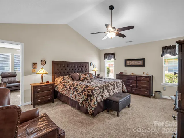 a bedroom with a bed dresser and a couch