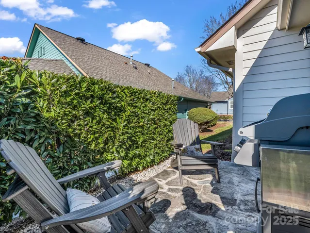 a backyard of a house with table and chairs