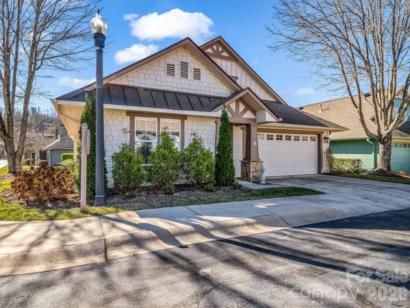 a view of a big house with a yard