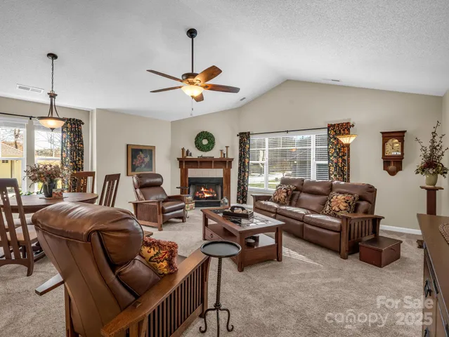 a living room with furniture a fireplace and a window