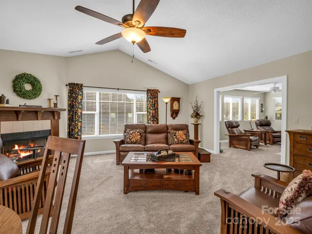 a living room with furniture and a floor to ceiling window