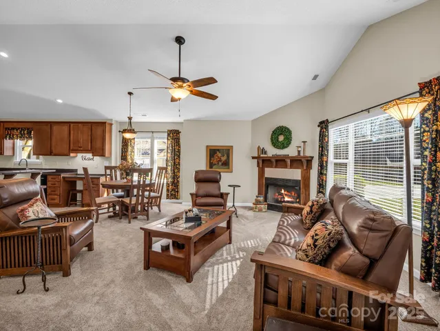 a living room with furniture fireplace and flat screen tv