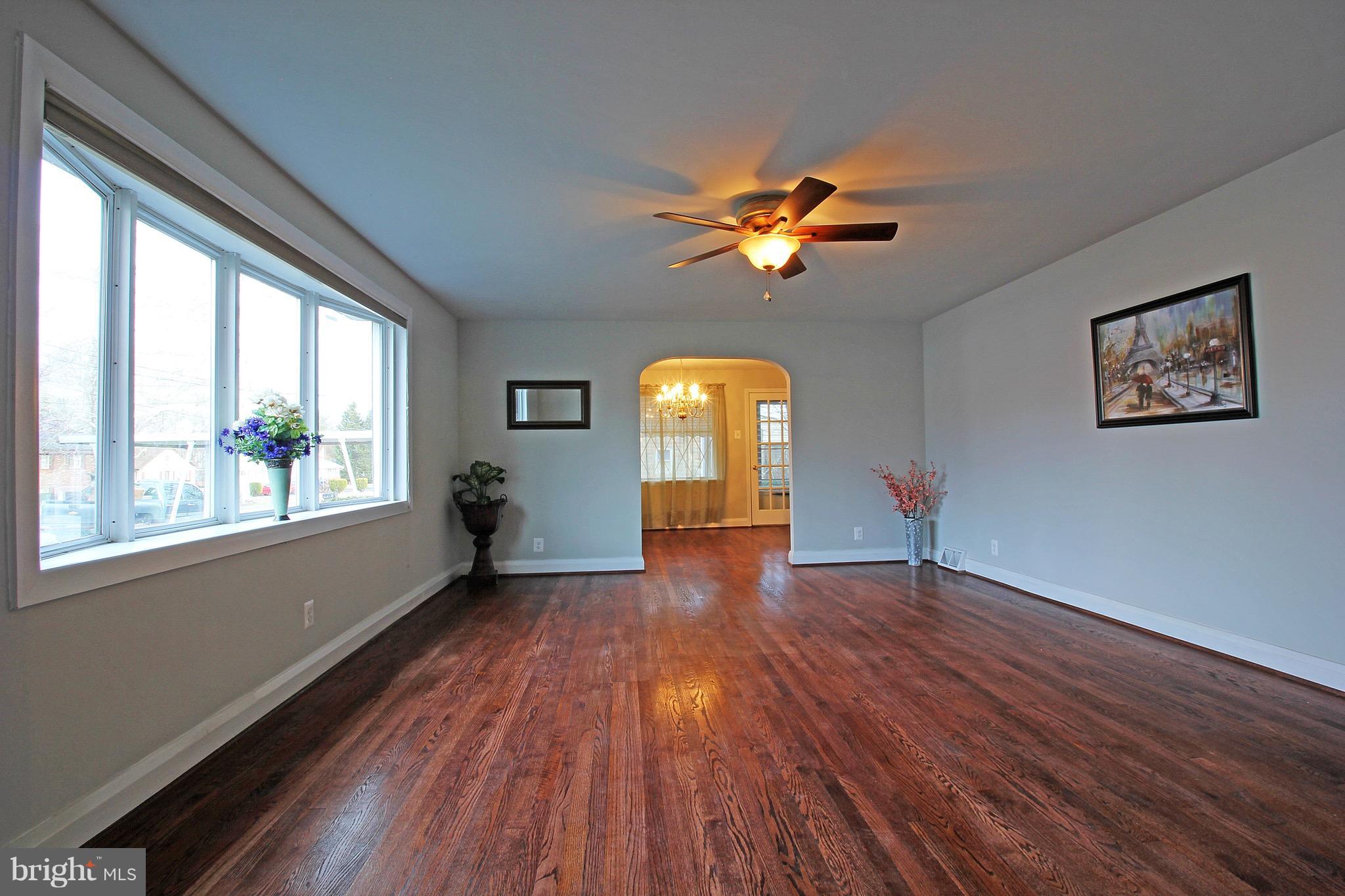 1217 Hillside Road Pasadena, MD 21122 - Photo 2 of 24 wooden floor in an empty room with a window