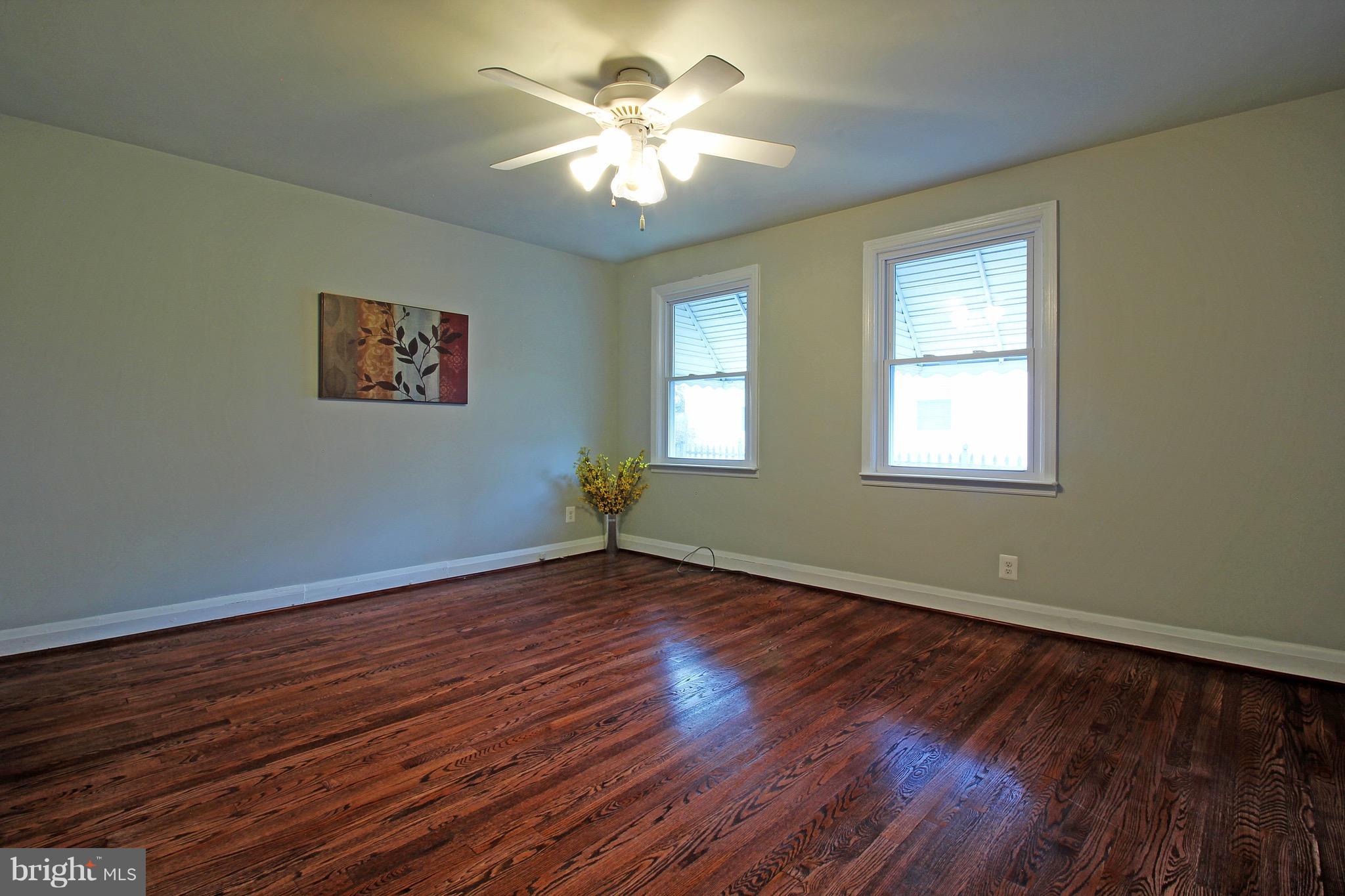 1217 Hillside Road Pasadena, MD 21122 - Photo 11 of 24 a view of empty room with wooden floor and fan
