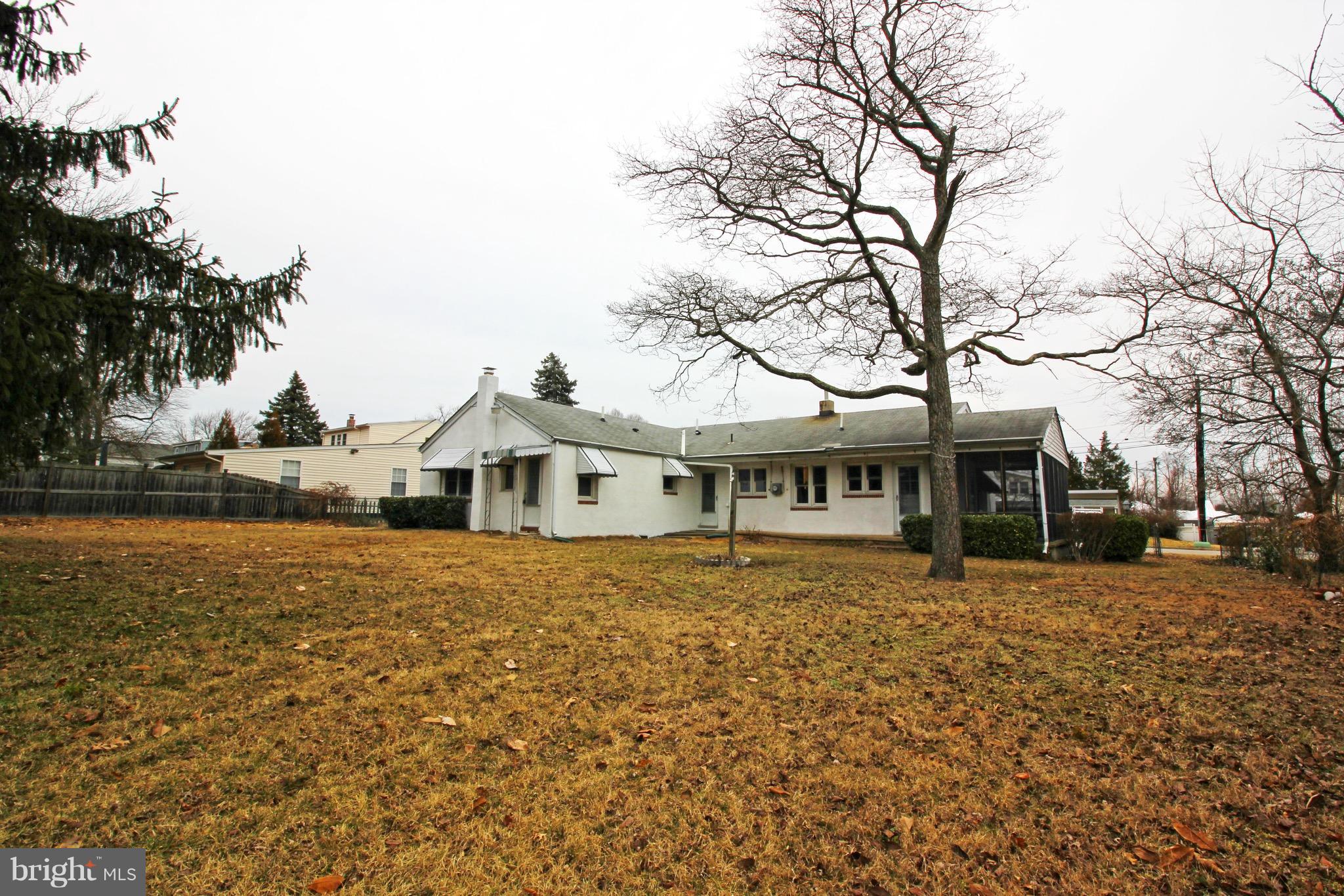 1217 Hillside Road Pasadena, MD 21122 - Photo 17 of 24 a front view of a house with a yard covered with trees