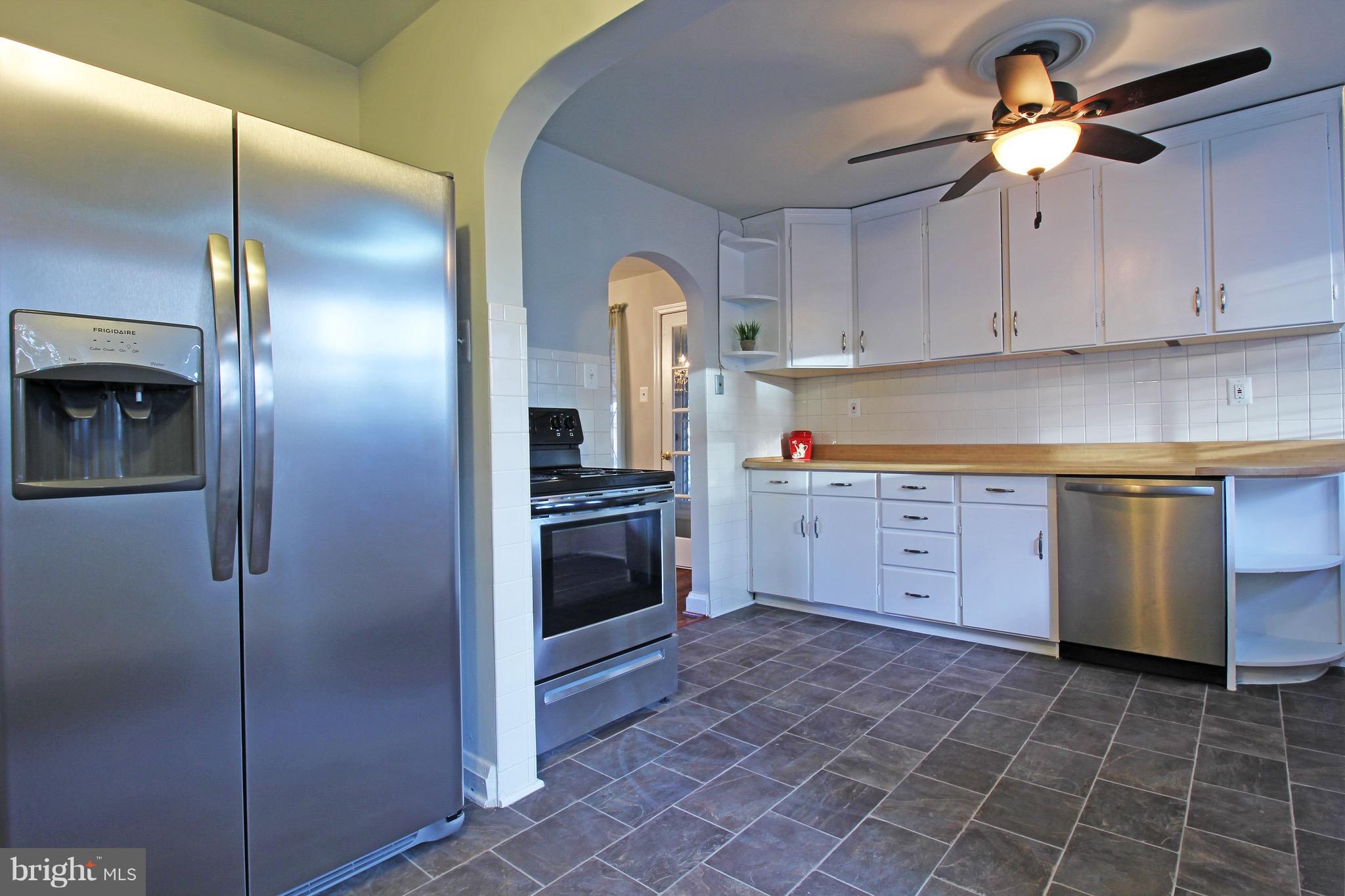 1217 Hillside Road Pasadena, MD 21122 - Photo 3 of 24 a kitchen with cabinets and stainless steel appliances