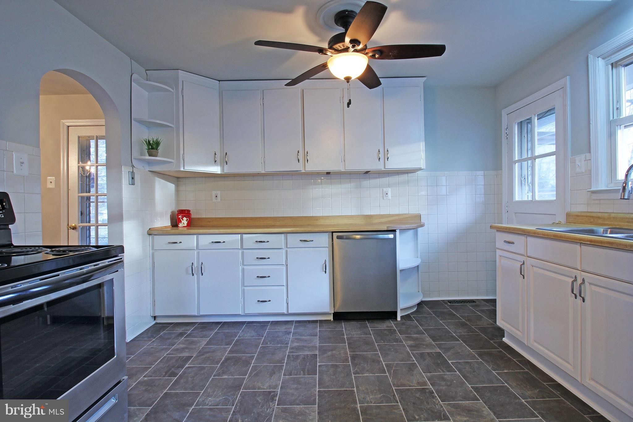 1217 Hillside Road Pasadena, MD 21122 - Photo 4 of 24 a kitchen with a cabinets and appliances