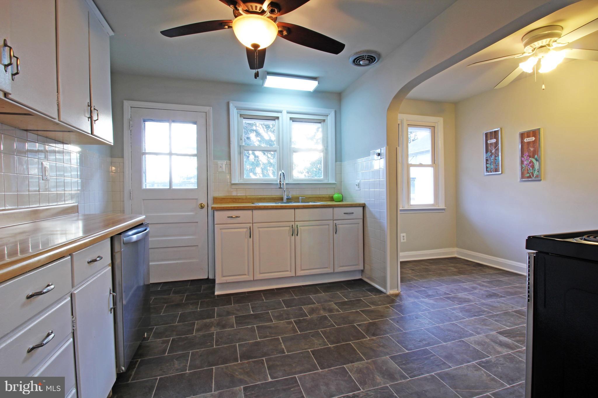 1217 Hillside Road Pasadena, MD 21122 - Photo 5 of 24 a kitchen with a sink a stove cabinets and counter space