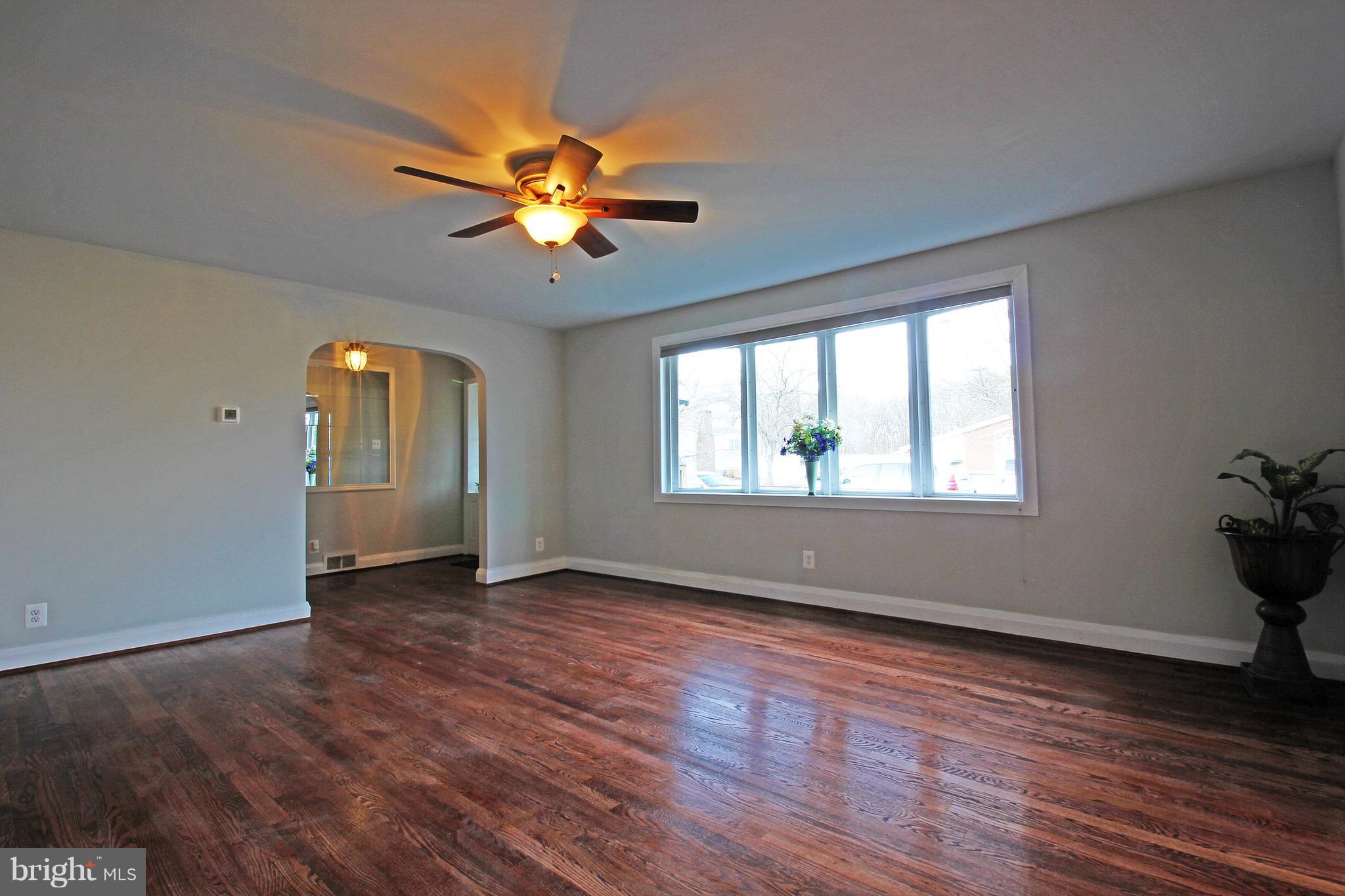 1217 Hillside Road Pasadena, MD 21122 - Photo 6 of 24 a view of empty room with wooden floor and fan