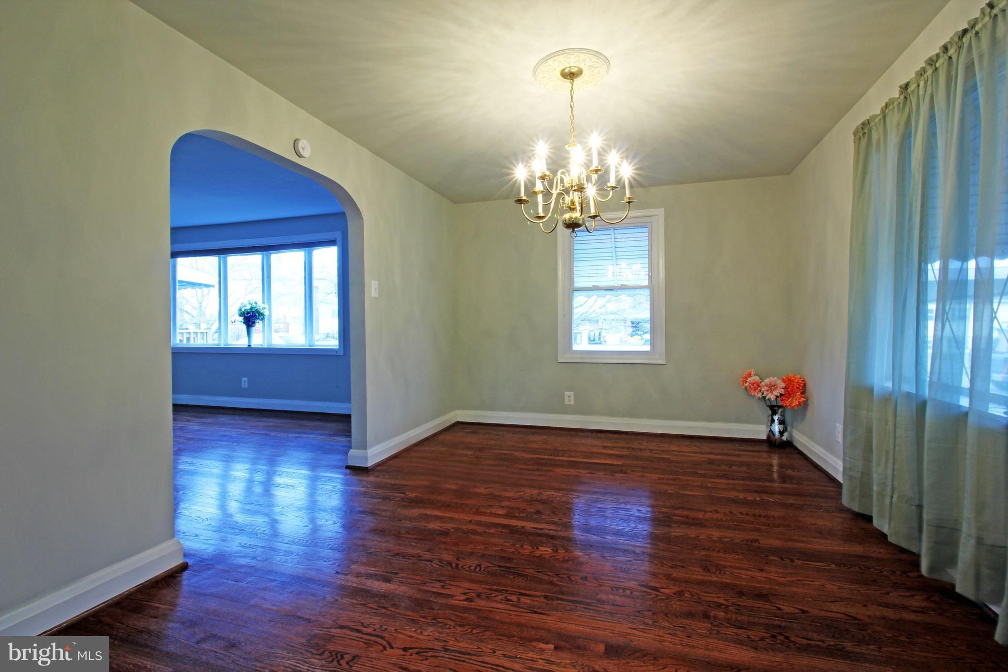 1217 Hillside Road Pasadena, MD 21122 - Photo 7 of 24 a view of a room with wooden flooring and chandelier