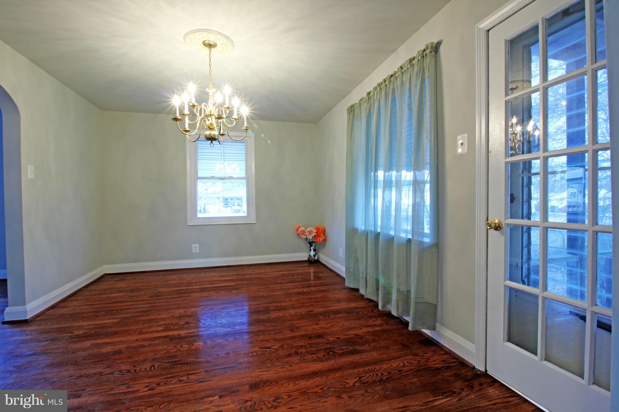 1217 Hillside Road Pasadena, MD 21122 - Photo 8 of 24 wooden floor in an empty room with a window
