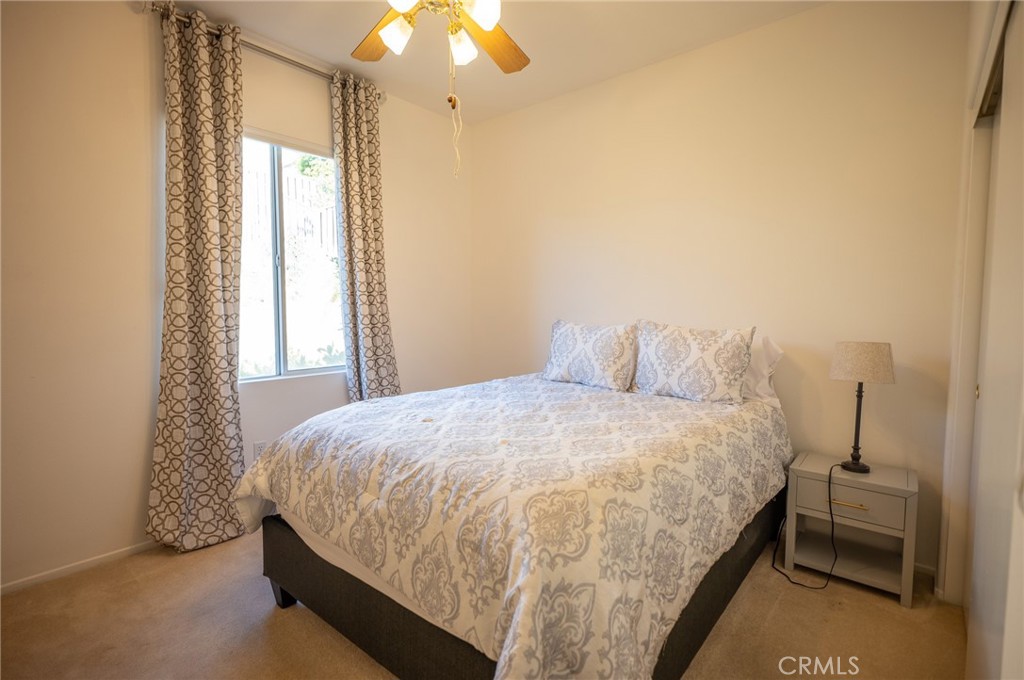 12207 Vía Santa Marta Sylmar, CA 91342 - Photo 13 of 39 a bedroom with a bed and a chandelier
