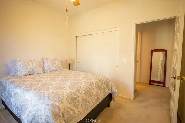 a large bed sitting in a bedroom next to a window