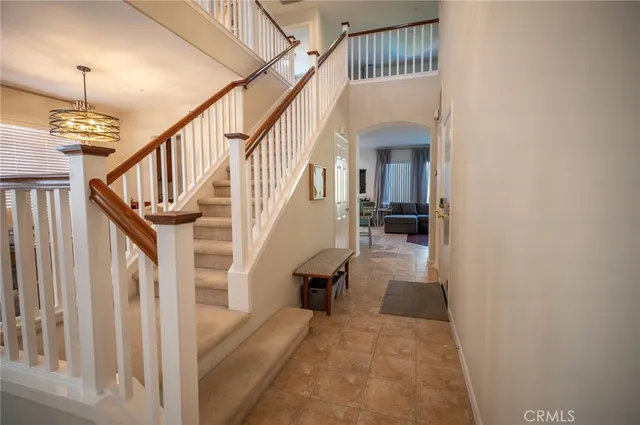a view of staircase with lots of frames on wall and wooden floor