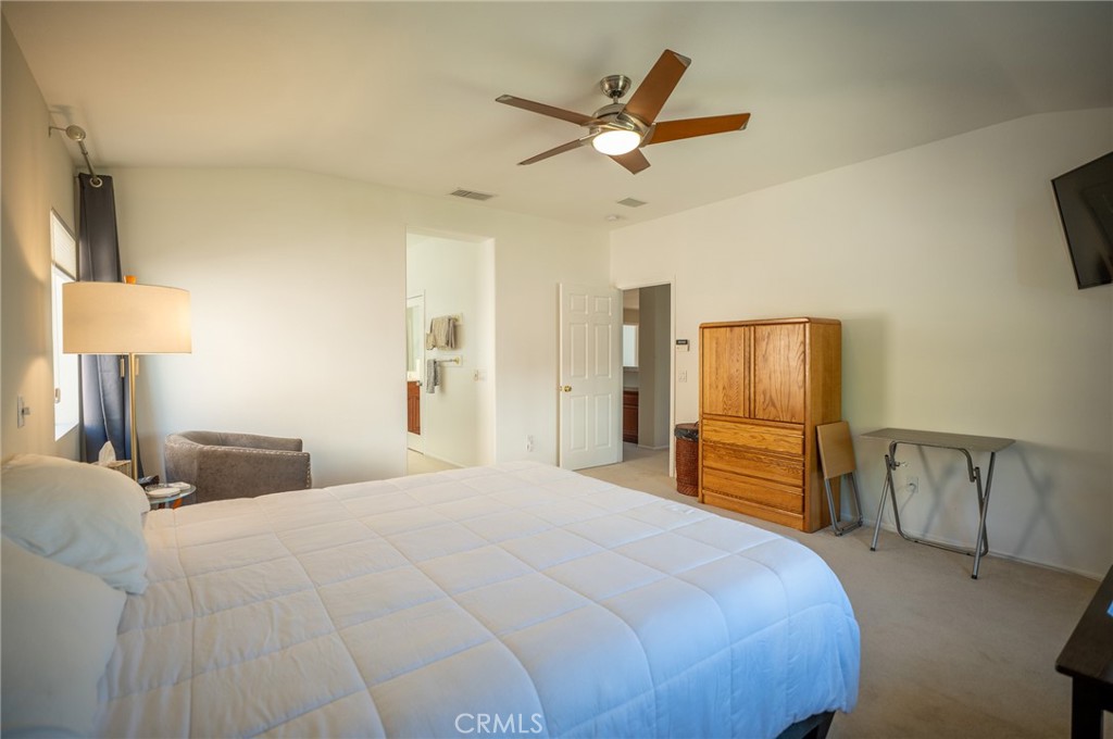 12207 Vía Santa Marta Sylmar, CA 91342 - Photo 25 of 39 a bedroom with a bed and a chandelier