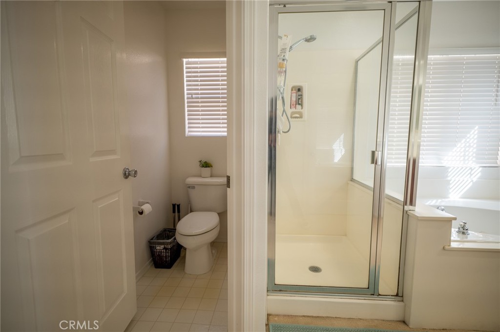 12207 Vía Santa Marta Sylmar, CA 91342 - Photo 27 of 39 a bathroom with a granite countertop shower mirror and toilet