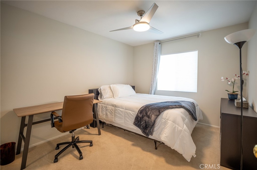 12207 Vía Santa Marta Sylmar, CA 91342 - Photo 28 of 39 a bedroom with a bed a desk and chair