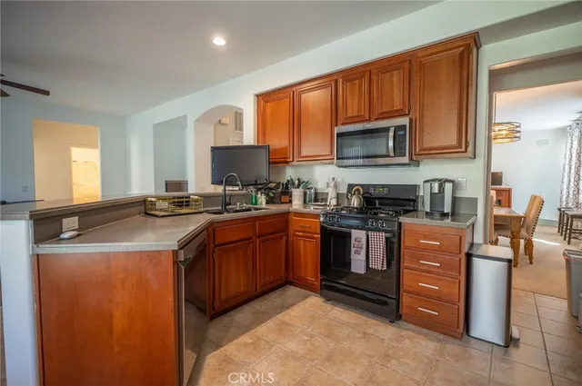 a kitchen with stainless steel appliances granite countertop a stove sink and cabinets