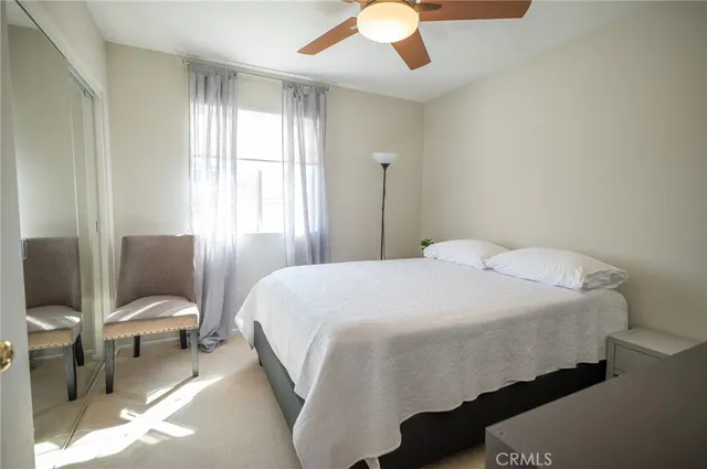 a bedroom with a bed and a mirror