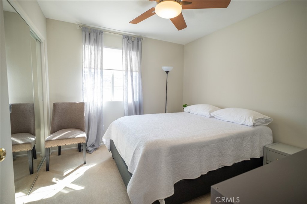 12207 Vía Santa Marta Sylmar, CA 91342 - Photo 32 of 39 a bedroom with a bed and a chandelier