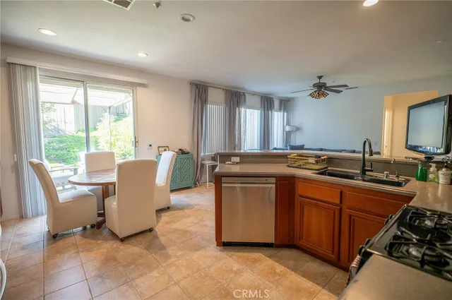 a large kitchen with kitchen island a sink a stove a dining table and chairs