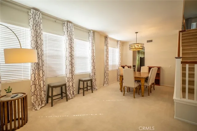 a dining room with furniture and a window